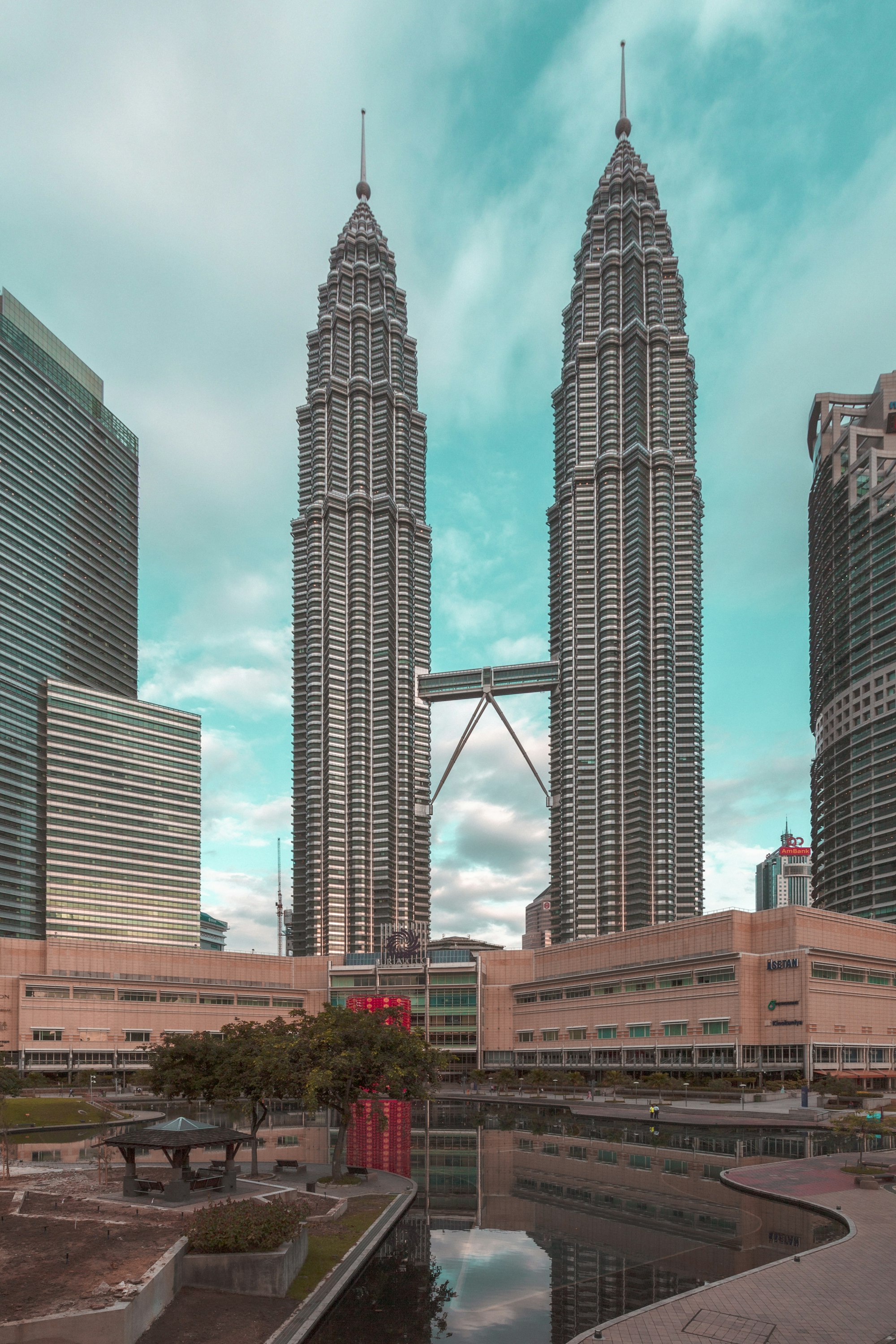 Petronas Twin Towers rising above Kuala Lumpur skyline with skybridge connecting the structures